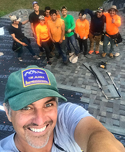 The RDG Roofing crew on a roof in Central Florida — owner Doug Richards in front